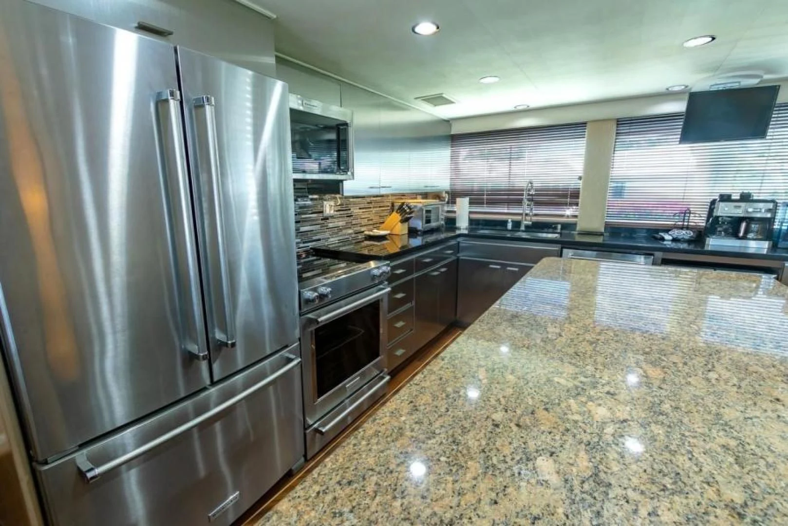 a large kitchen with stainless steel appliances aboard K Yacht for Sale