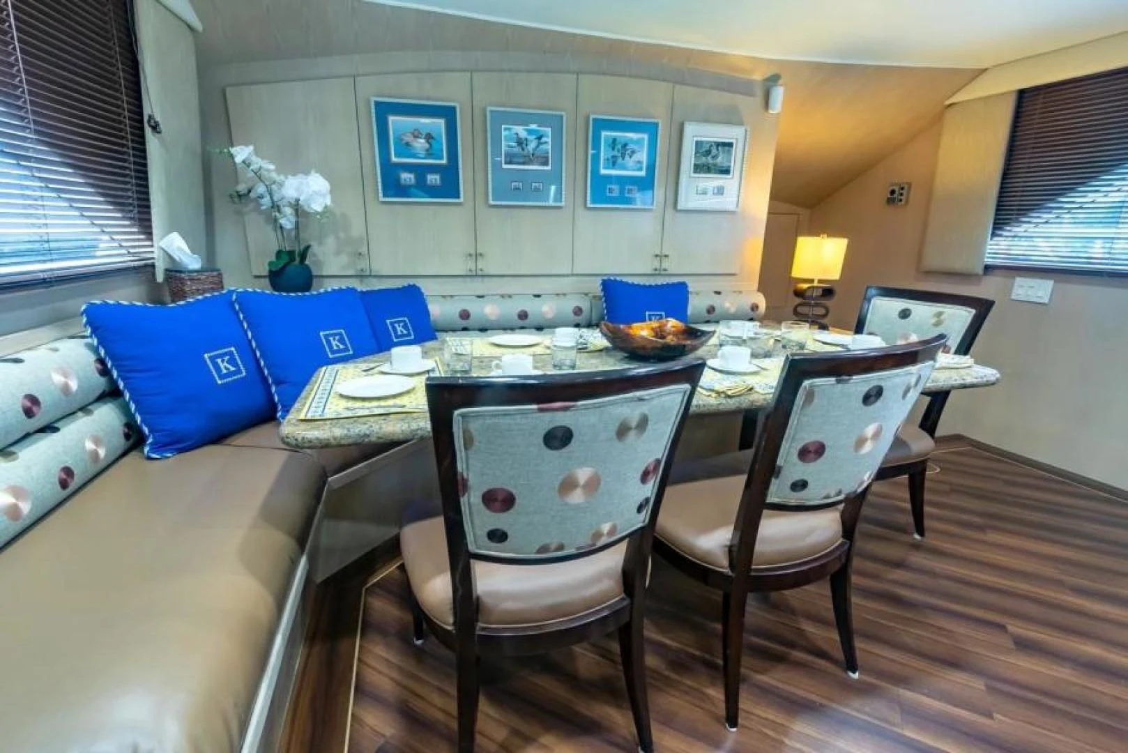 a dining table with chairs and a couch aboard K Yacht for Sale
