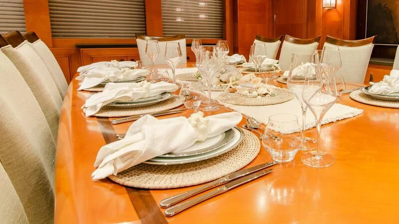 a table with plates and glasses aboard PLEIADES II Yacht for Sale