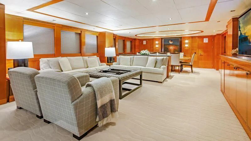 a living room with couches and a table aboard PLEIADES II Yacht for Sale