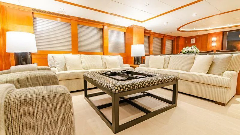 a living room with a couch and a table aboard PLEIADES II Yacht for Sale