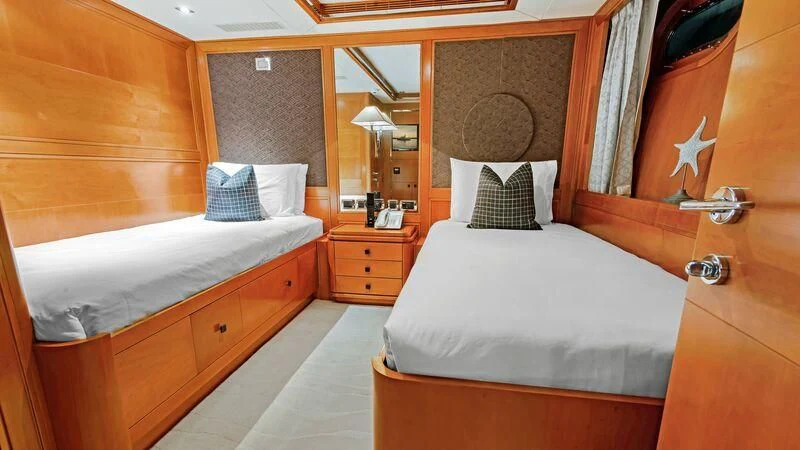 a room with a bed and a mirror aboard PLEIADES II Yacht for Sale