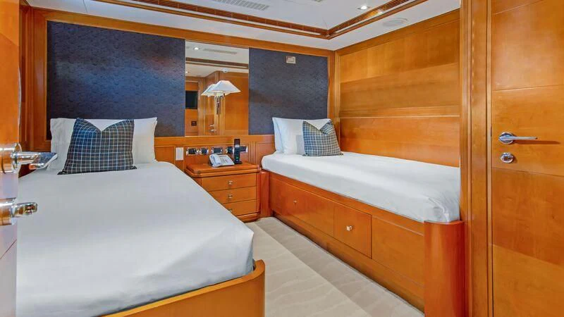 a room with a bed and a mirror aboard PLEIADES II Yacht for Sale