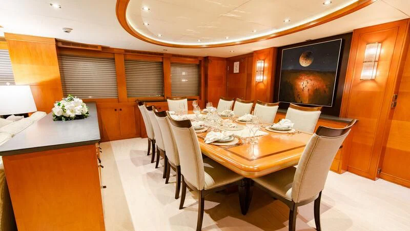 a large dining table in a restaurant aboard PLEIADES II Yacht for Sale