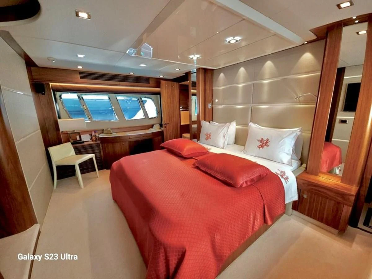 a room with a bed and a chair aboard FAMILY SPIRIT Yacht for Sale