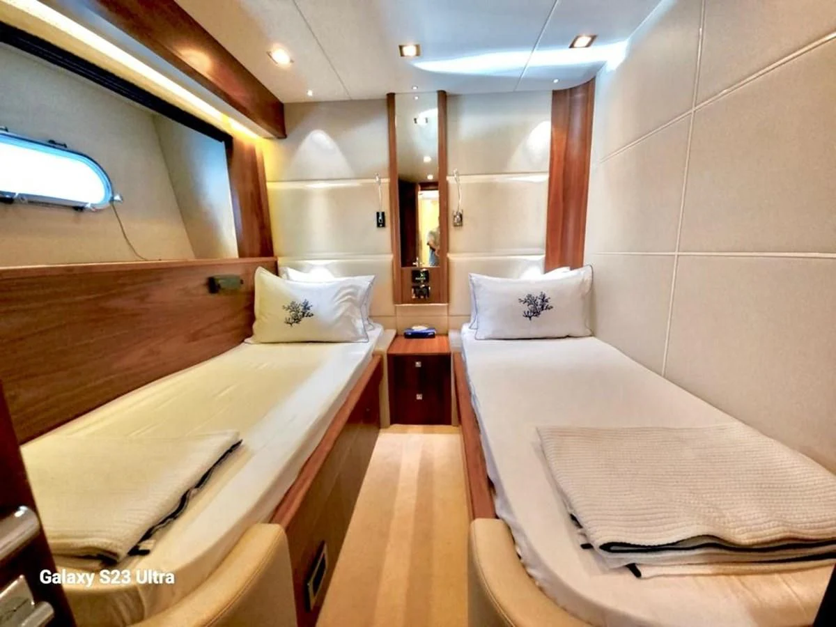 a room with beds and a pillow aboard FAMILY SPIRIT Yacht for Sale