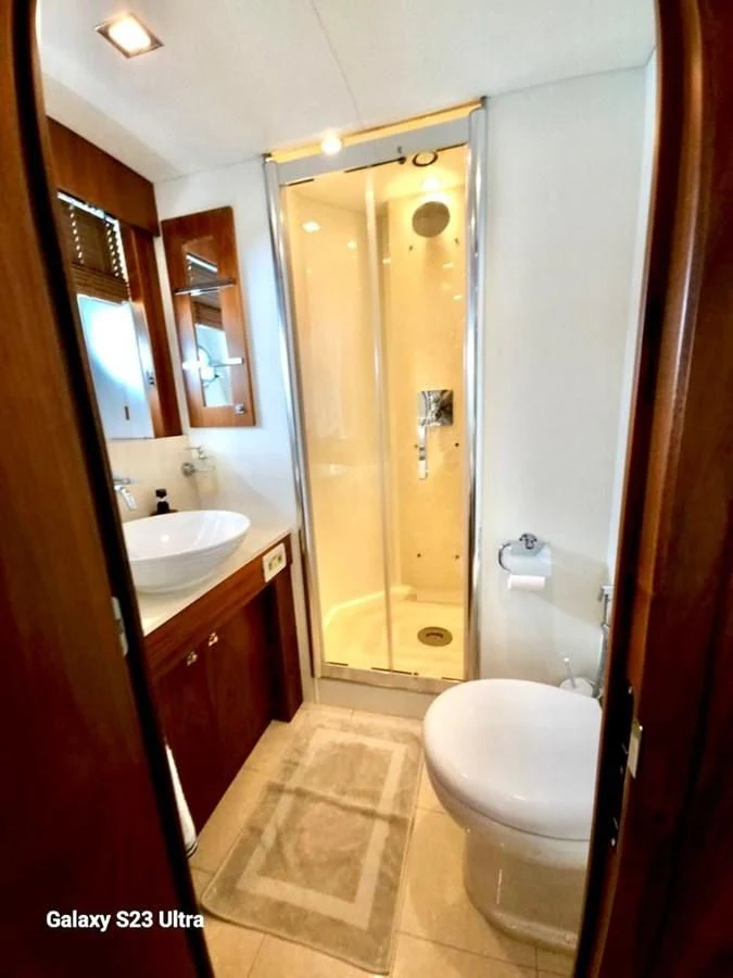 a bathroom with a glass shower door aboard FAMILY SPIRIT Yacht for Sale