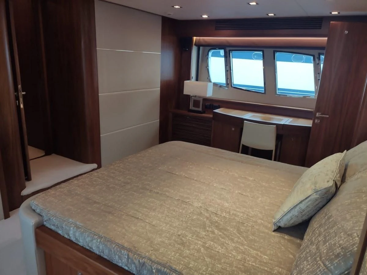 a bed with a window aboard FAMILY SPIRIT Yacht for Sale