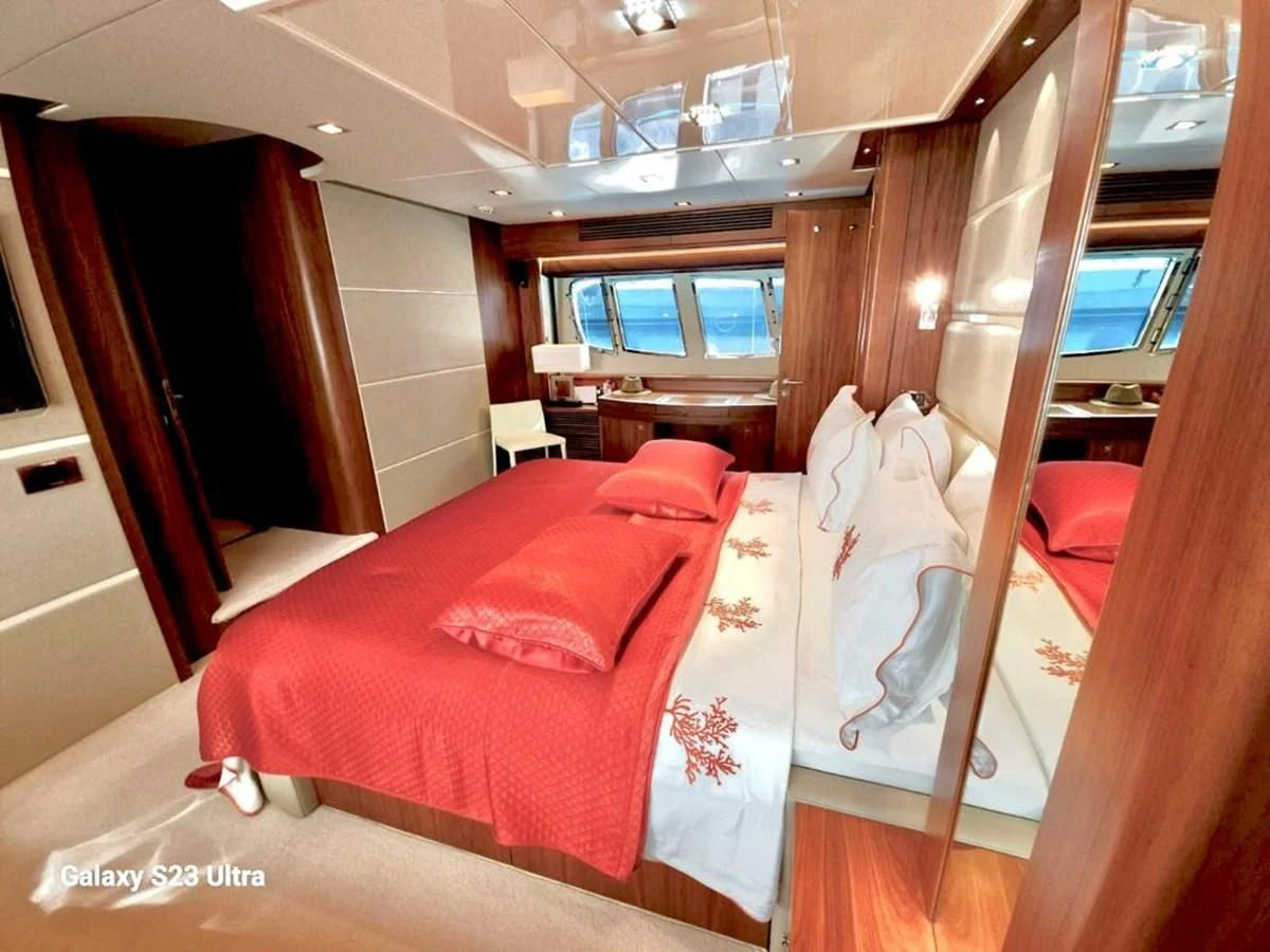 a room with a bed and a chair aboard FAMILY SPIRIT Yacht for Sale
