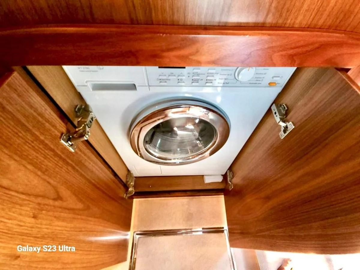 a washing machine on a wooden floor aboard FAMILY SPIRIT Yacht for Sale