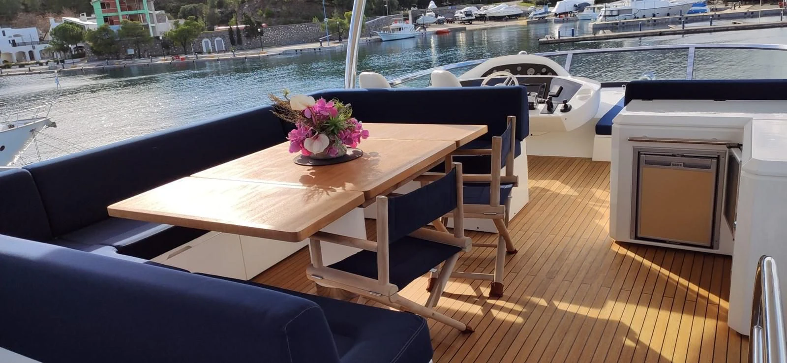 a table with chairs on it next to a body of water aboard FAMILY SPIRIT Yacht for Sale