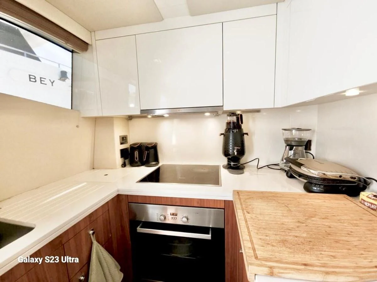 a kitchen with white cabinets aboard FAMILY SPIRIT Yacht for Sale