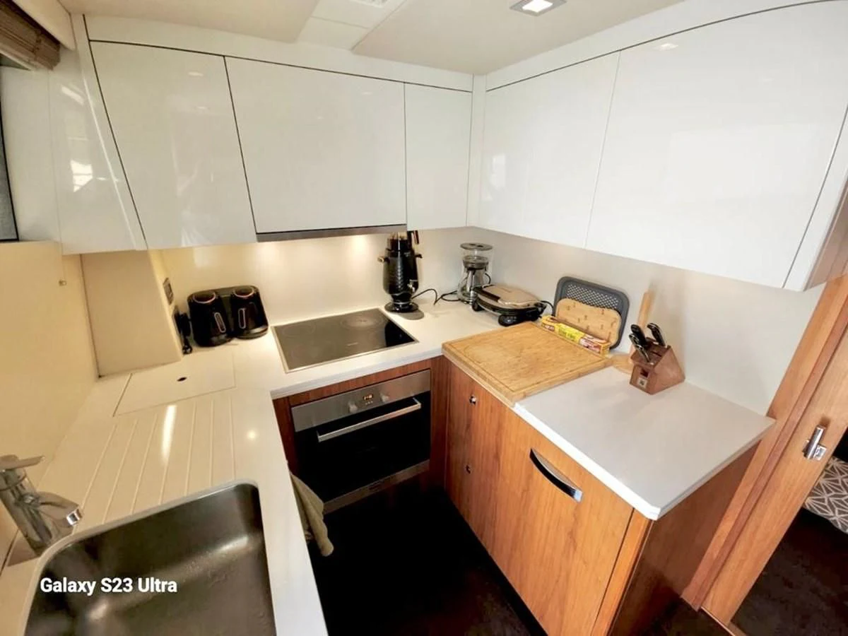 a kitchen with white cabinets aboard FAMILY SPIRIT Yacht for Sale
