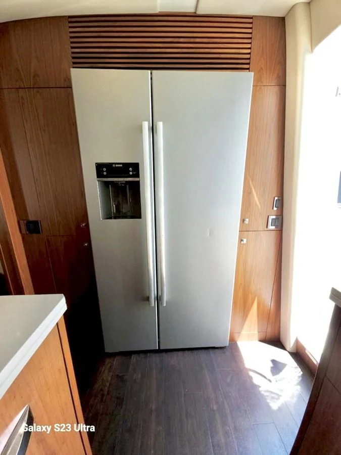 a kitchen with a stainless steel refrigerator aboard FAMILY SPIRIT Yacht for Sale