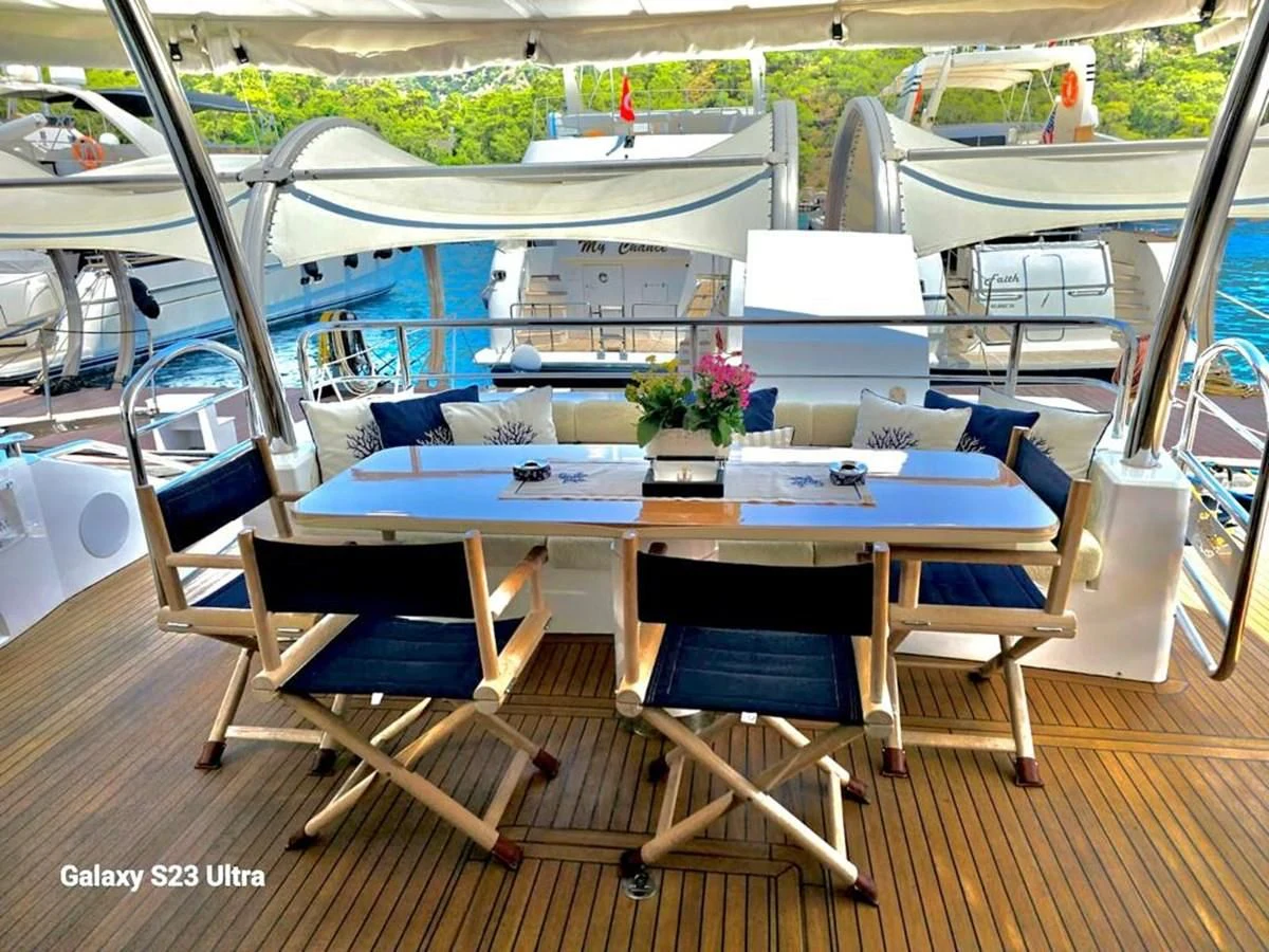a room with a table and chairs aboard FAMILY SPIRIT Yacht for Sale