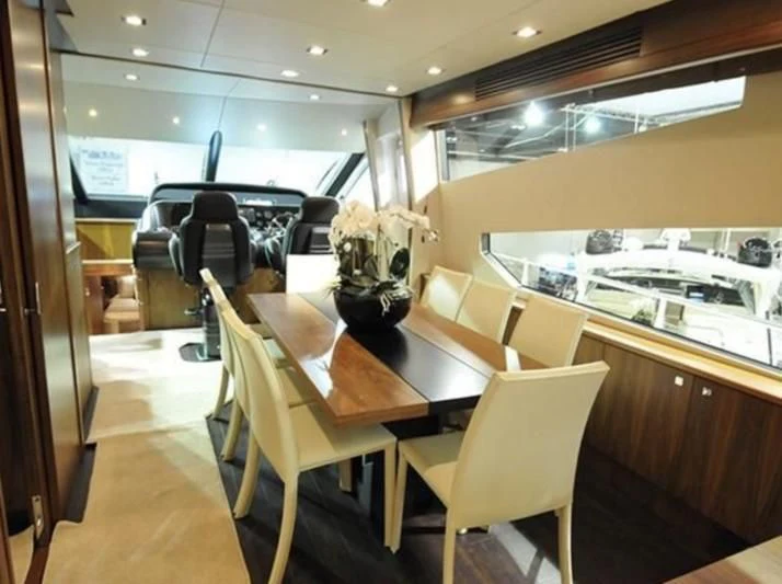 a room with a table and chairs aboard FAMILY SPIRIT Yacht for Sale