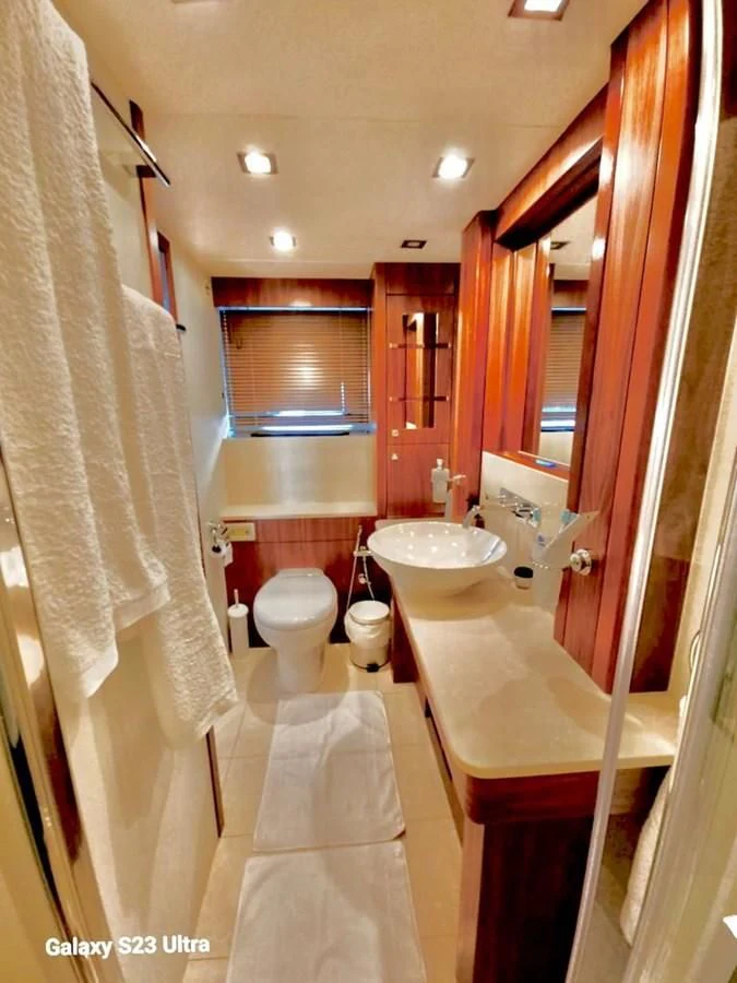 a bathroom with a tub sink and toilet aboard FAMILY SPIRIT Yacht for Sale