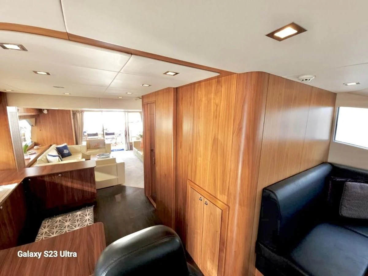 a room with a desk and chairs aboard FAMILY SPIRIT Yacht for Sale