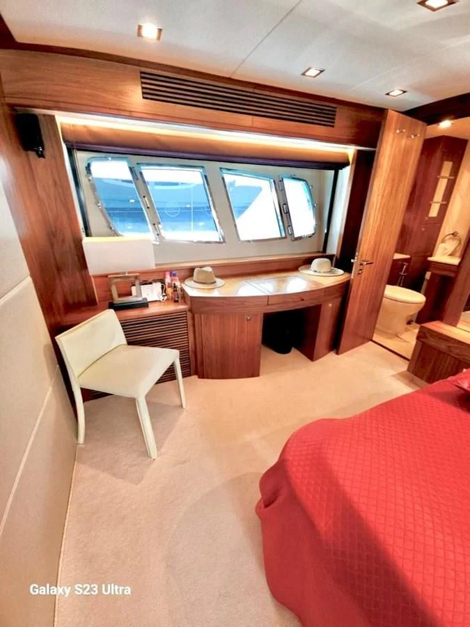 a room with a bed and desk aboard FAMILY SPIRIT Yacht for Sale
