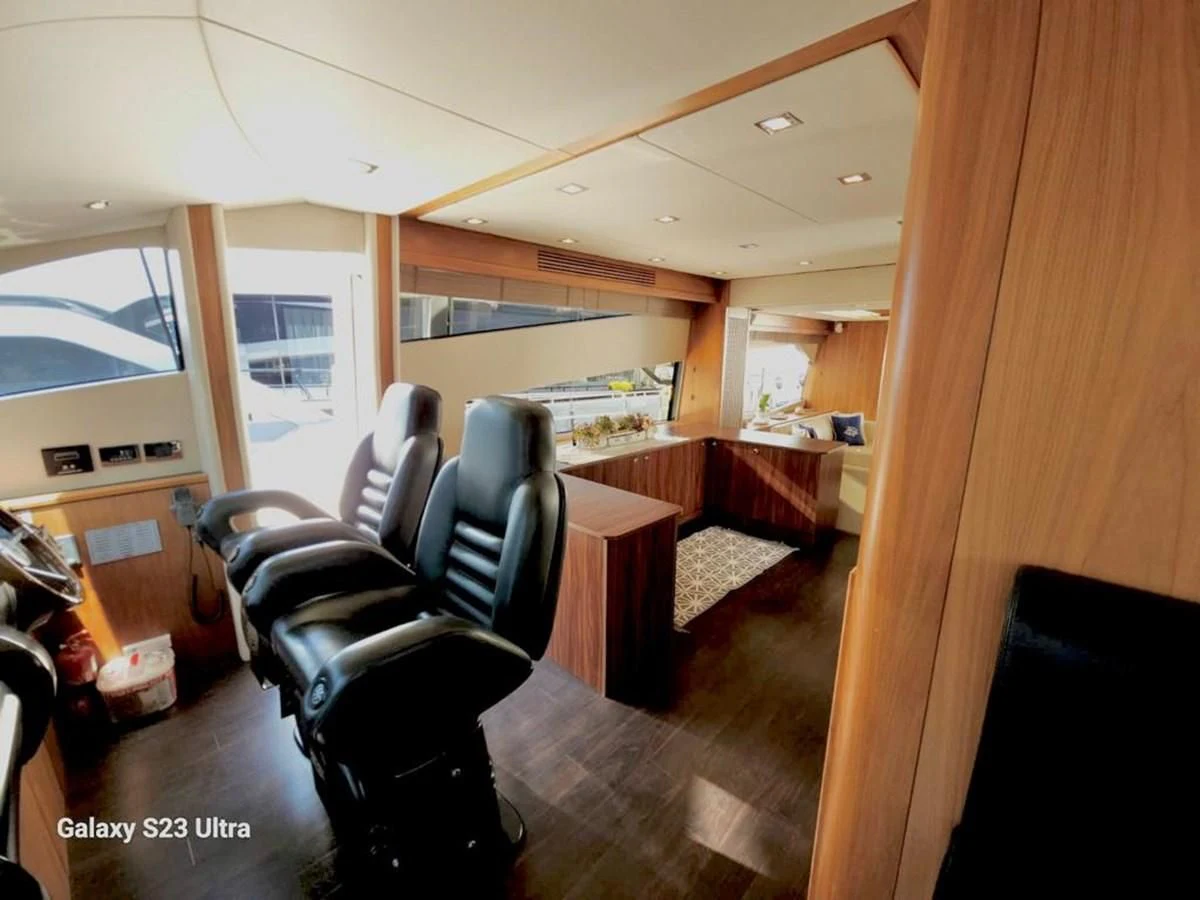 a room with chairs and a table aboard FAMILY SPIRIT Yacht for Sale