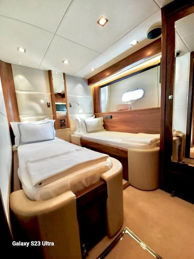 a room with a bed and a chair aboard FAMILY SPIRIT Yacht for Sale