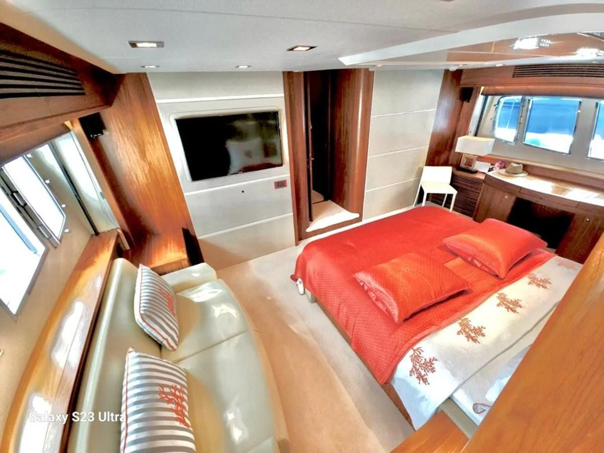 a bedroom with a bed and a window aboard FAMILY SPIRIT Yacht for Sale