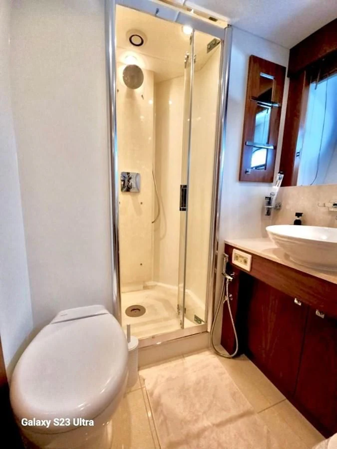 a bathroom with a glass shower door aboard FAMILY SPIRIT Yacht for Sale