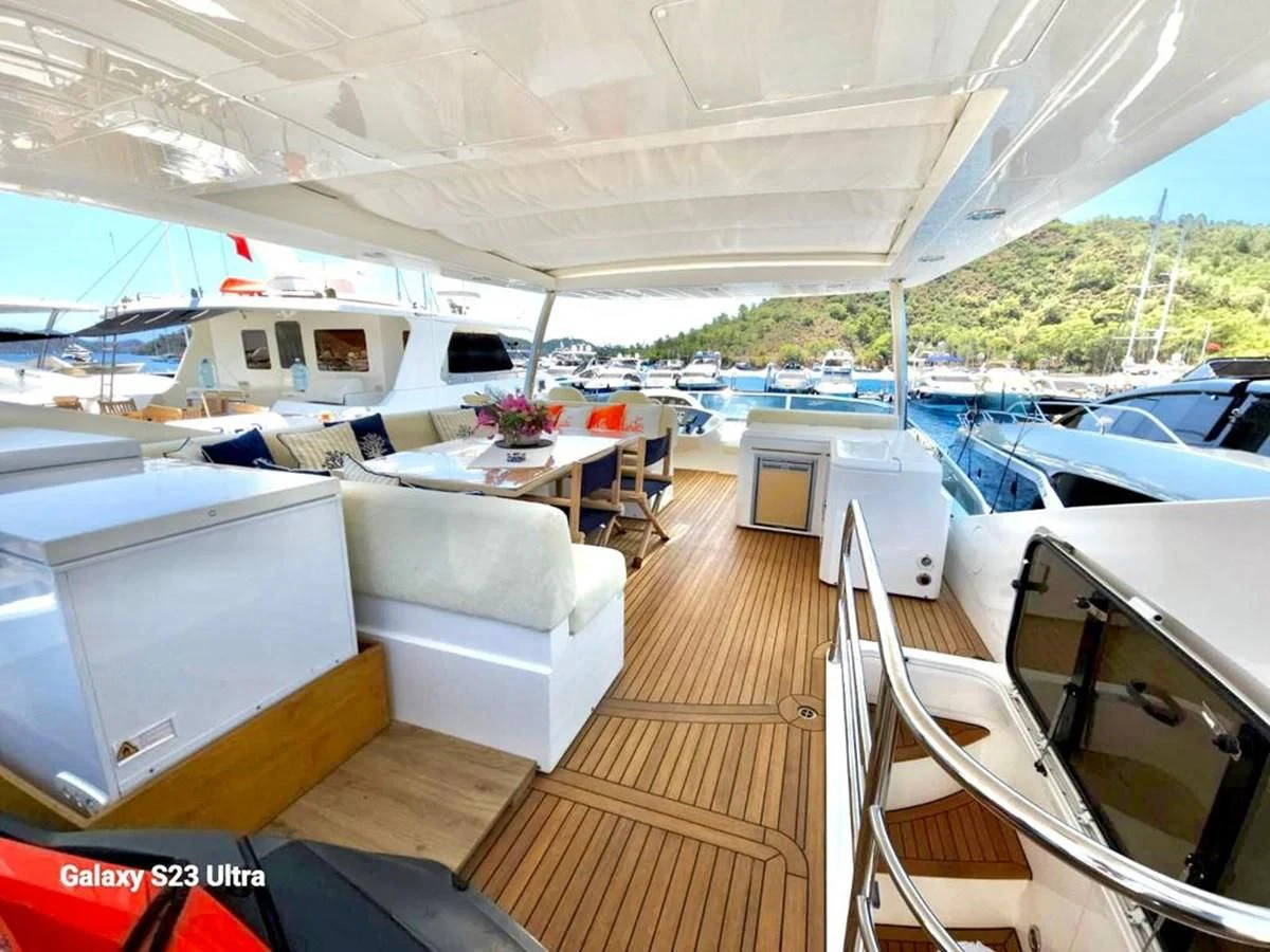 a deck with a boat and a table on it aboard FAMILY SPIRIT Yacht for Sale