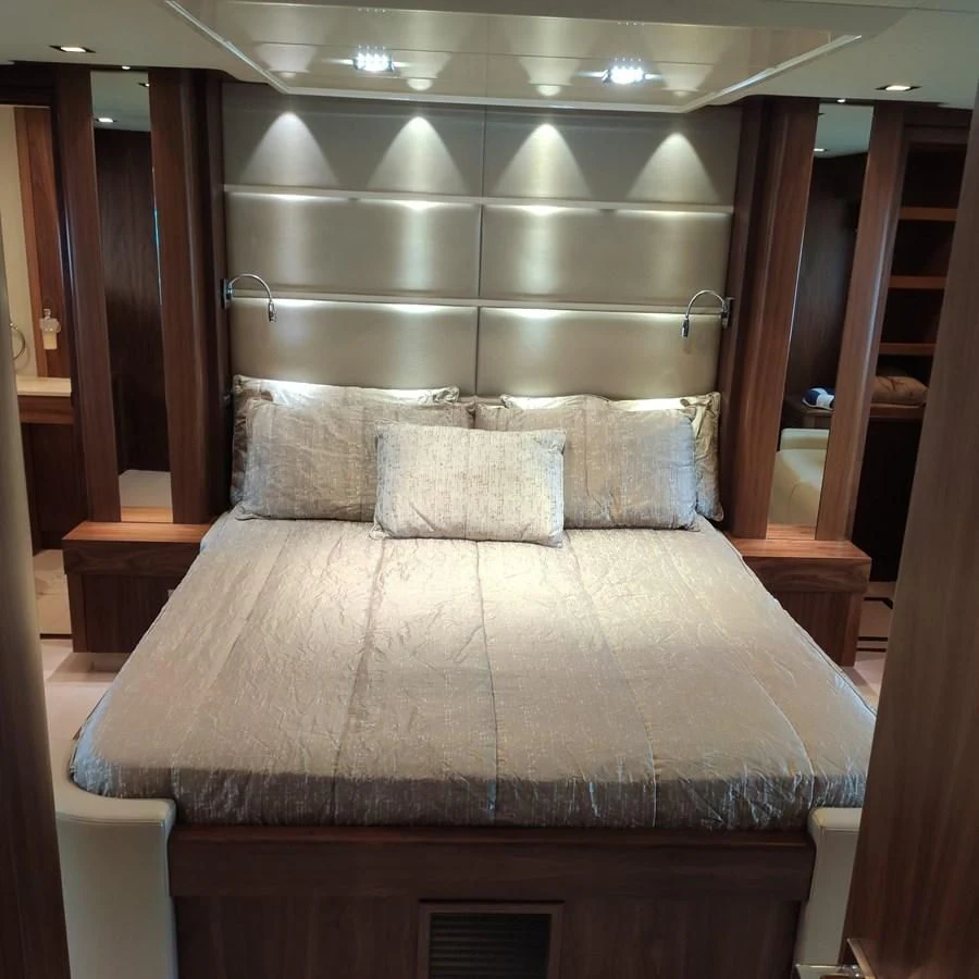 a bed with a white comforter aboard FAMILY SPIRIT Yacht for Sale