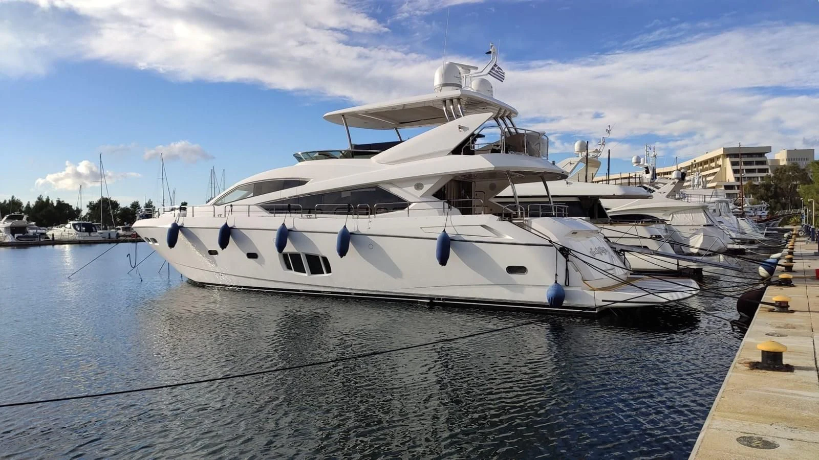 a white boat in a harbor aboard FAMILY SPIRIT Yacht for Sale