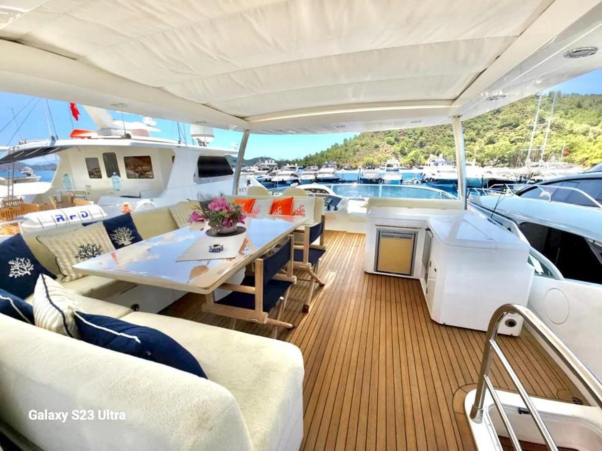 a boat with a table and chairs aboard FAMILY SPIRIT Yacht for Sale
