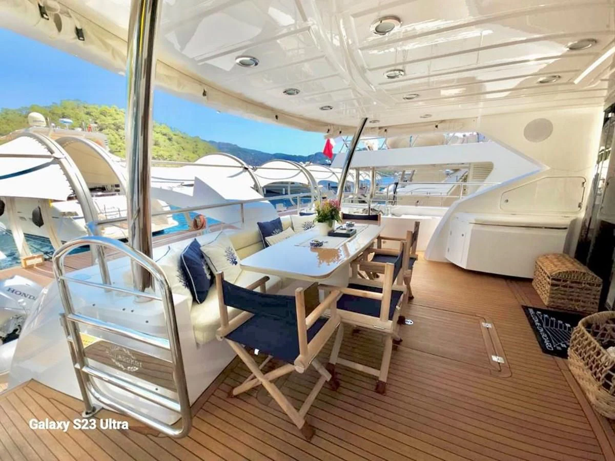 a boat with chairs and tables aboard FAMILY SPIRIT Yacht for Sale