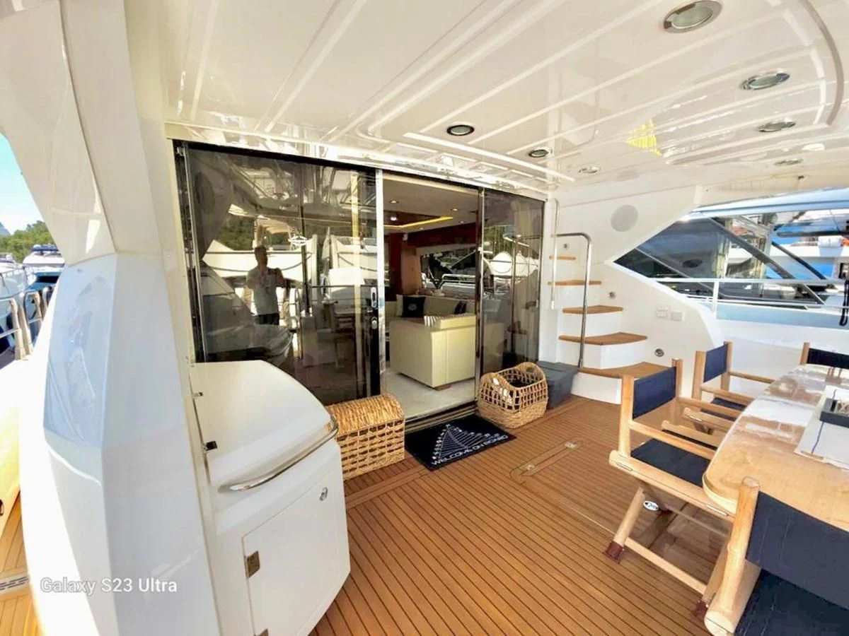 a room with a table chairs and a large window aboard FAMILY SPIRIT Yacht for Sale