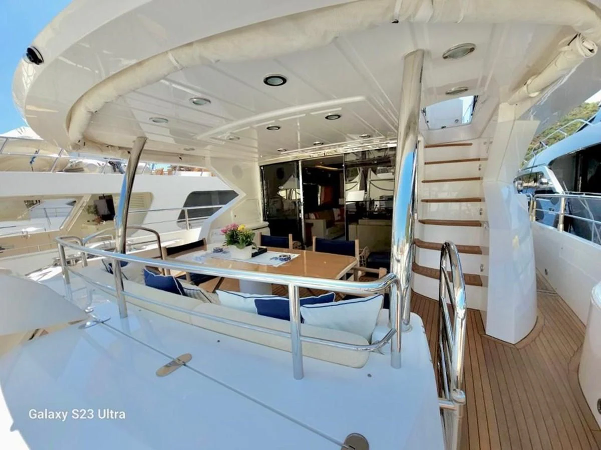 a boat with a table and chairs aboard FAMILY SPIRIT Yacht for Sale