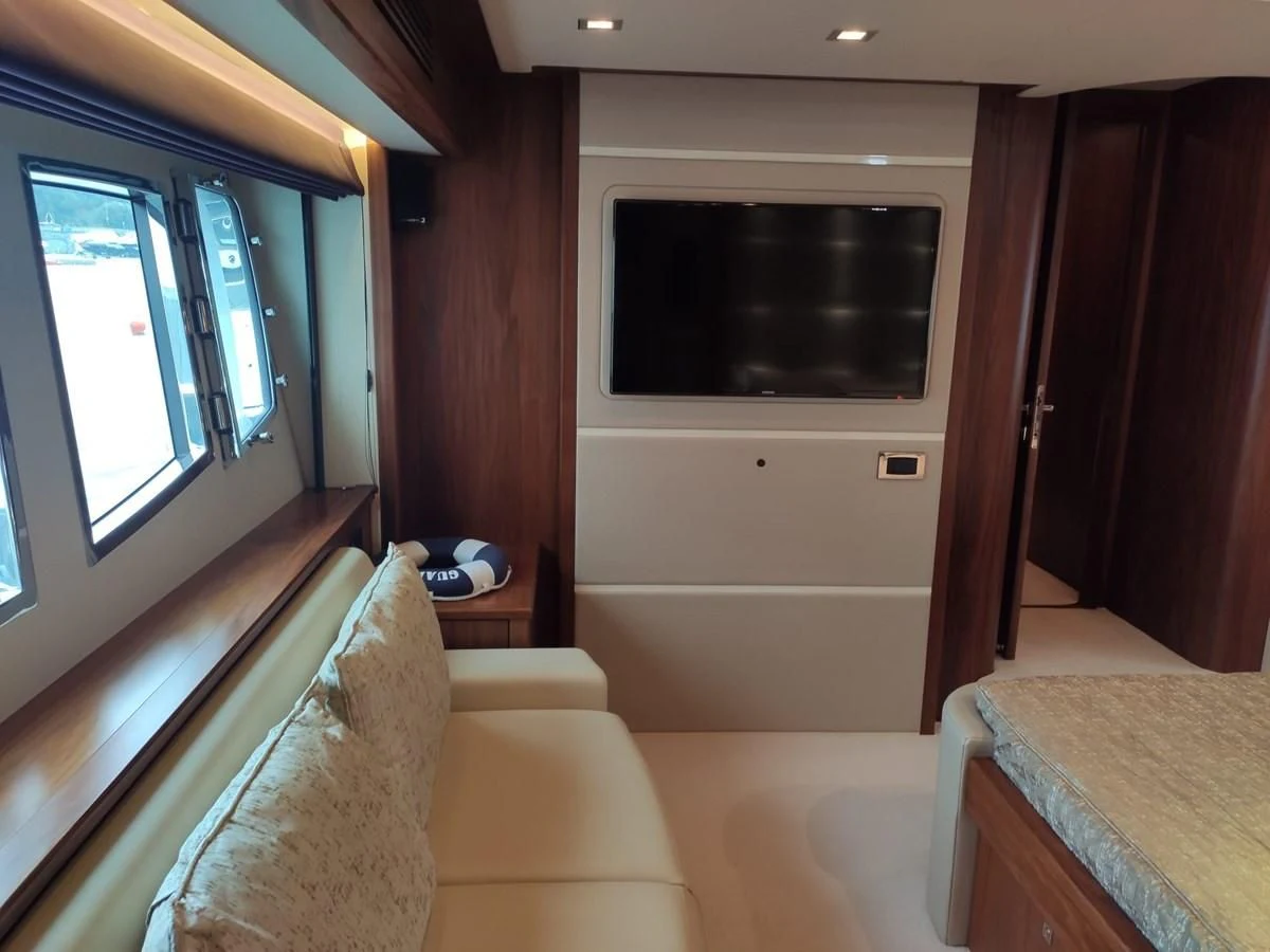 a room with a bed and a television aboard FAMILY SPIRIT Yacht for Sale
