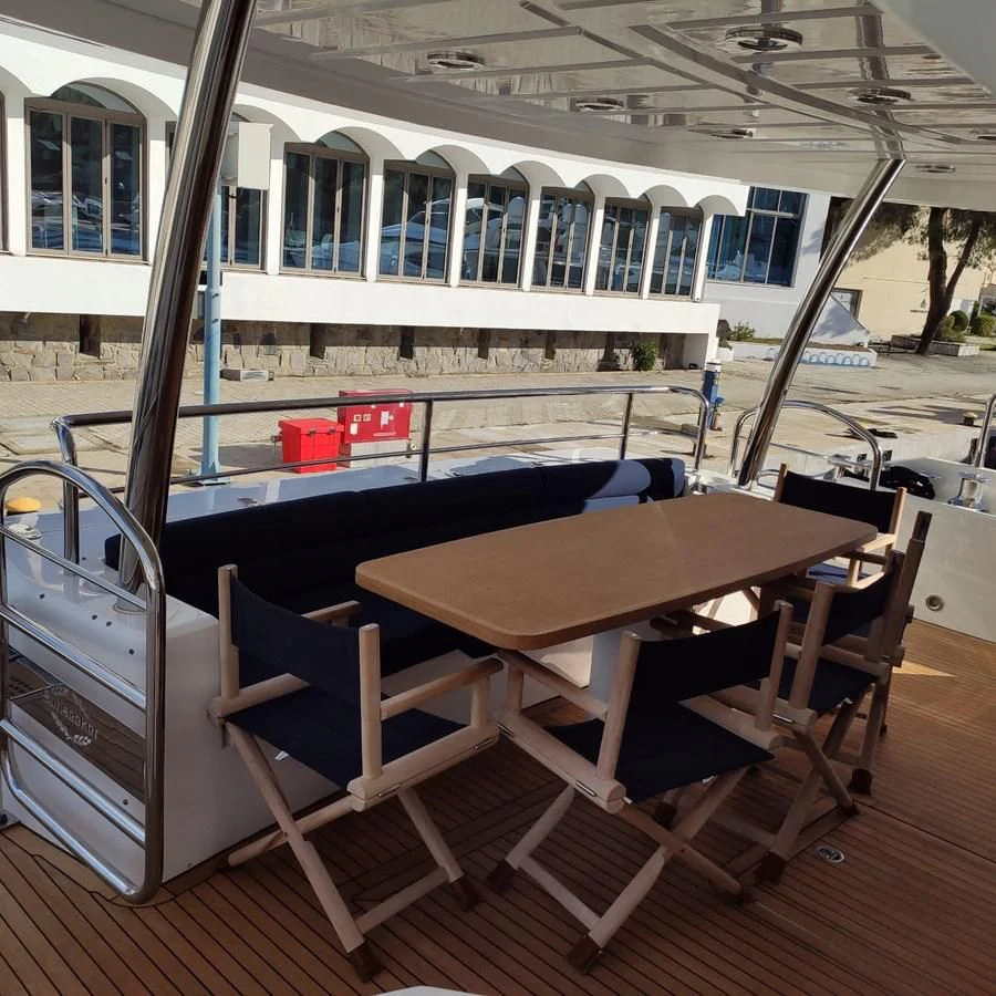 a table and chairs on a deck aboard FAMILY SPIRIT Yacht for Sale