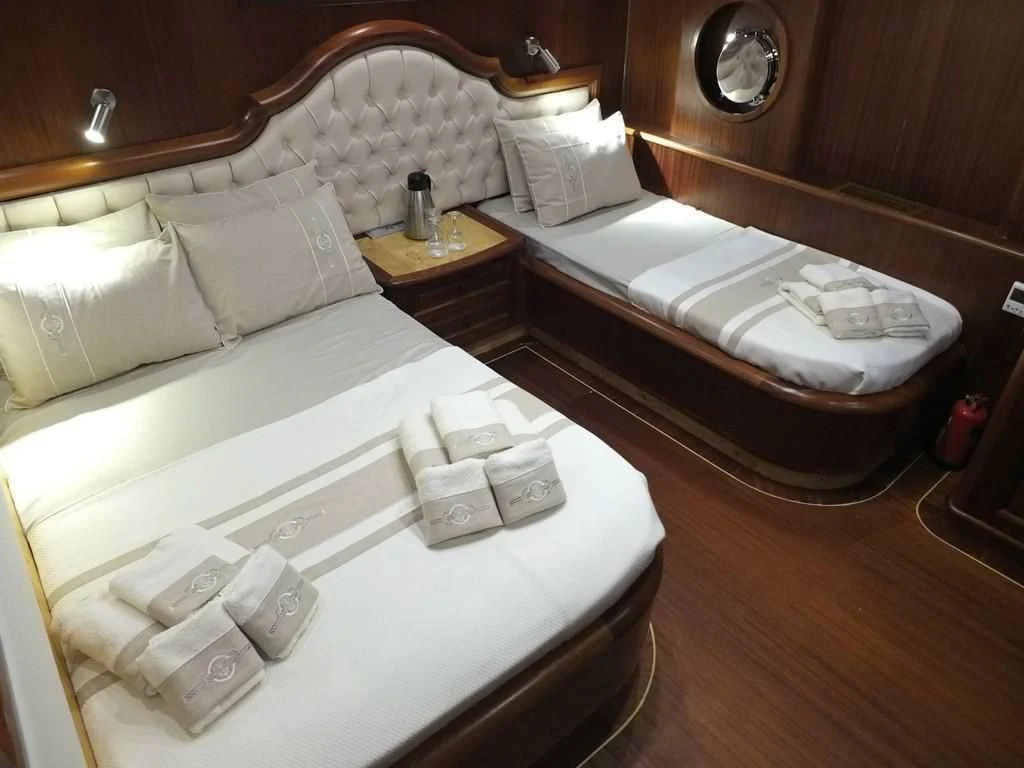 a hotel room with a bed and a mirror aboard KAPTAN MEHMET BUGRA Yacht for Sale