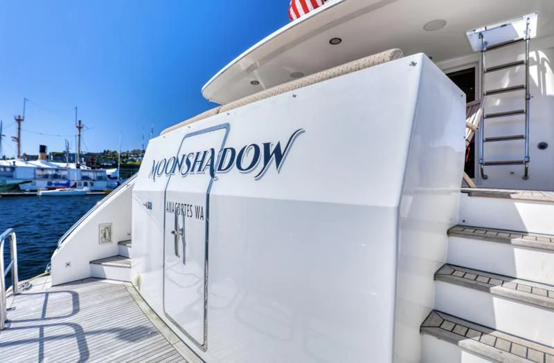 a boat with a sign on the front aboard MOONSHADOW Yacht for Sale