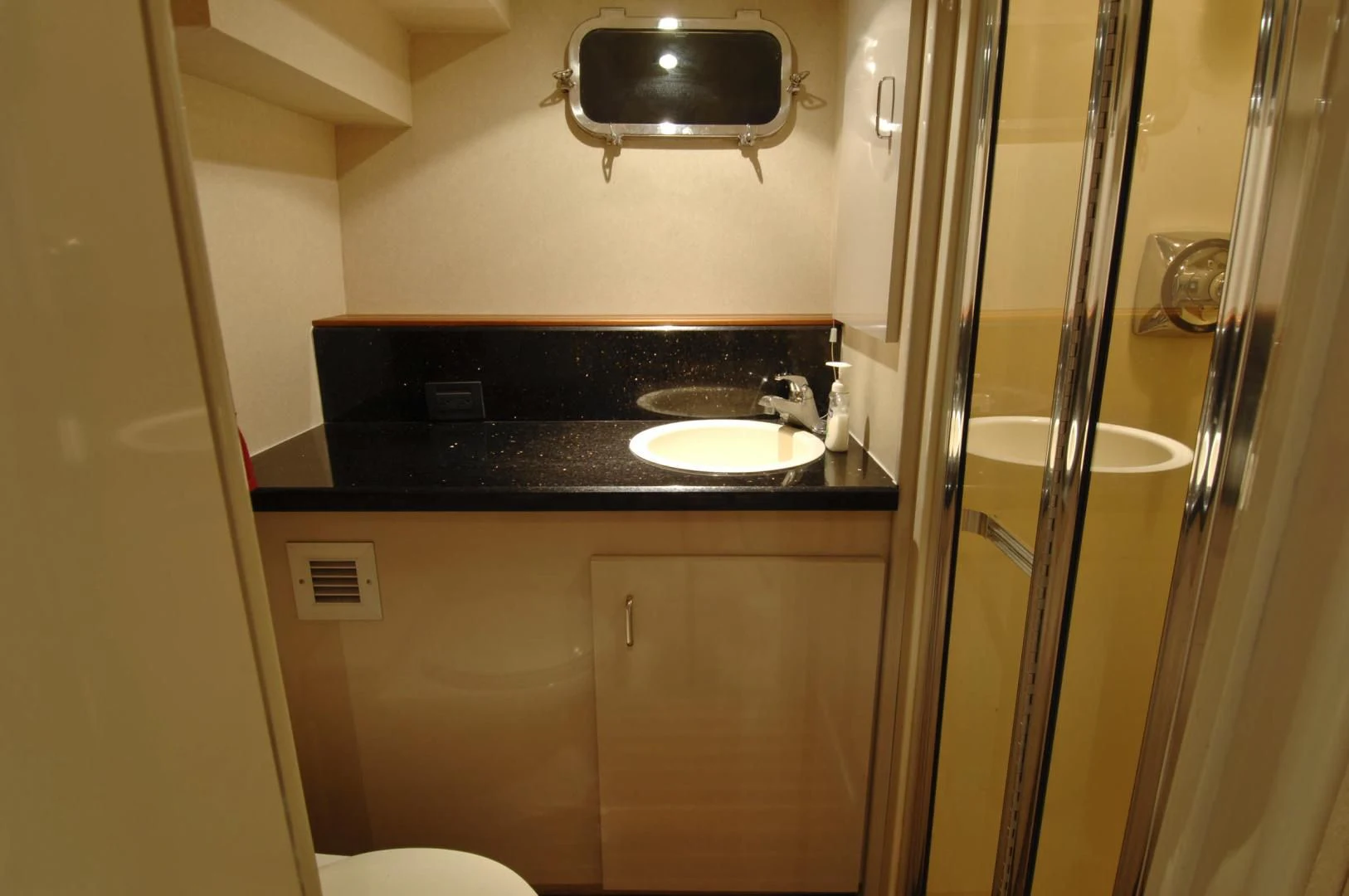 a bathroom with a sink and a tv on the wall aboard MOONSHADOW Yacht for Sale