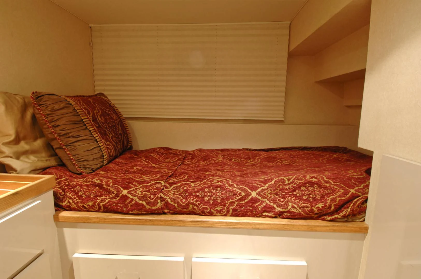 a bed with a red blanket aboard MOONSHADOW Yacht for Sale