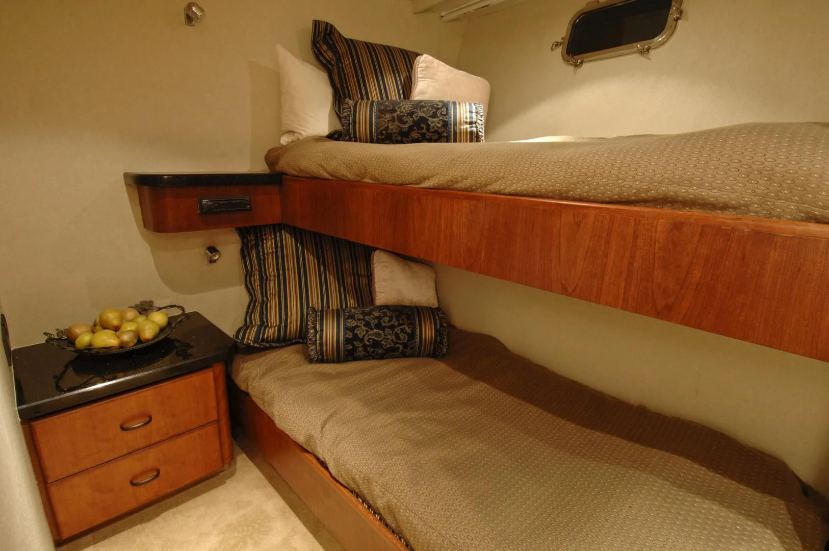 a bed with a tray of fruit on it aboard MOONSHADOW Yacht for Sale
