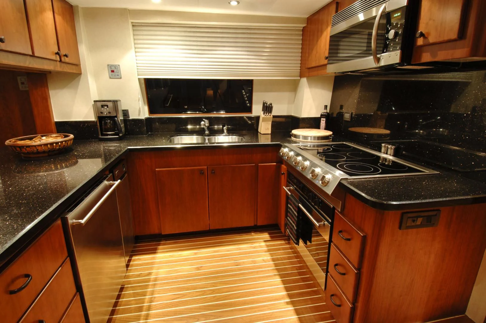 a kitchen with wooden cabinets aboard MOONSHADOW Yacht for Sale
