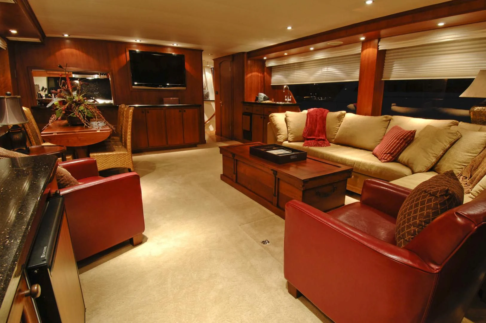 a living room with a couch and a tv aboard MOONSHADOW Yacht for Sale