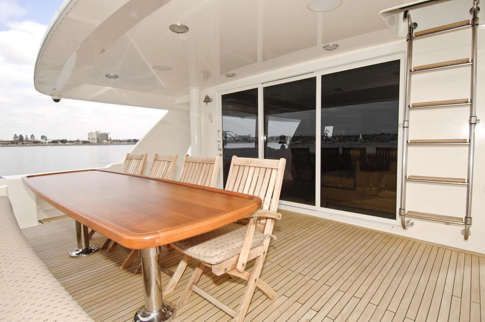 a table and chairs on a deck aboard MOONSHADOW Yacht for Sale