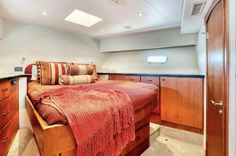 a bedroom with a bed and a closet aboard MOONSHADOW Yacht for Sale