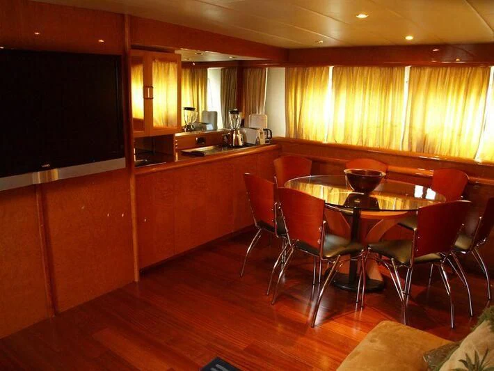 a room with a table and chairs aboard WINSOME Yacht for Sale