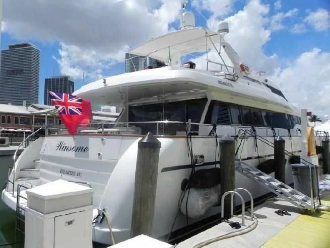 a large white boat with a red flag on the front aboard WINSOME Yacht for Sale