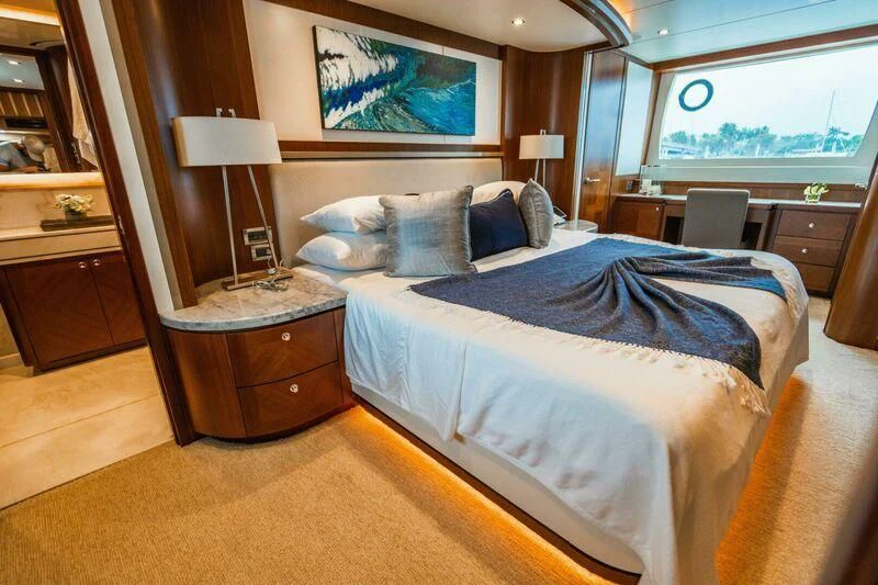 a bedroom with a bed and a desk aboard OA Yacht for Sale