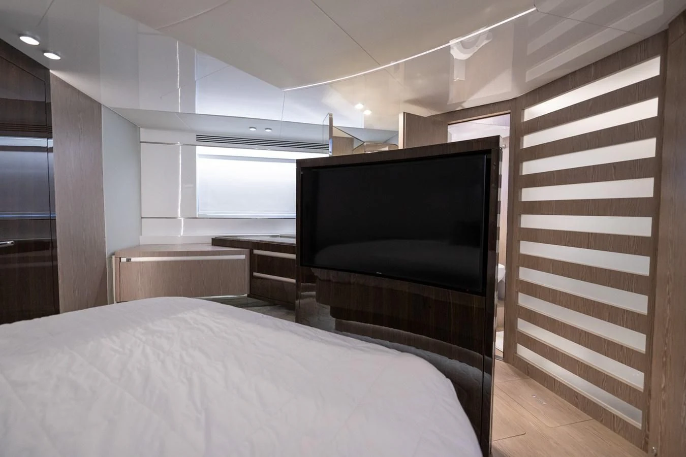 a bedroom with a tv and a bed aboard CANDELARIA Yacht for Sale