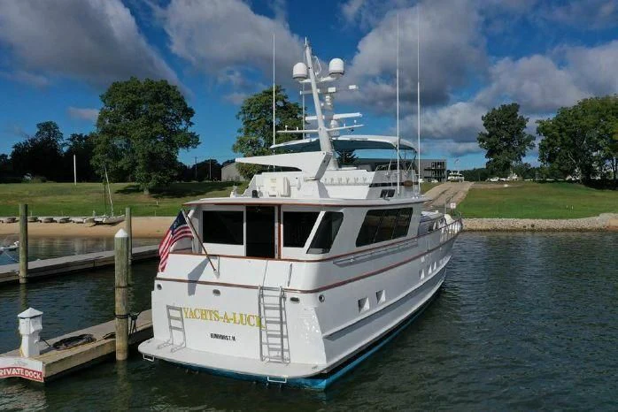 a white boat docked at a pier aboard YACHTS A LUCK Yacht for Sale